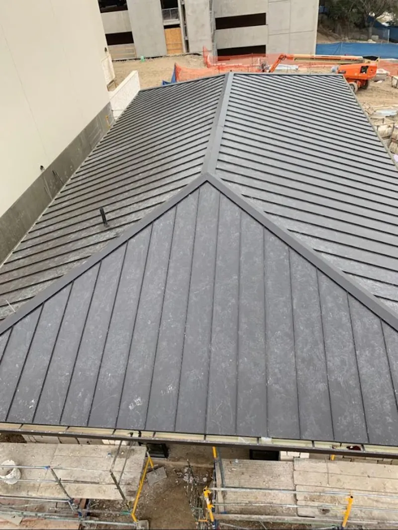 Commercial metal roof construction with crane equipment in Bridgeport